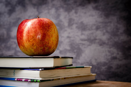 Textbooks, apple and blackboard