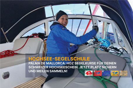 Seglerin setzt am Vordeck einer Yacht ein weisses Segel bei ruhigem Wetter.