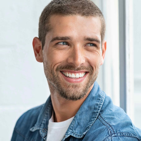 Lachender Erwachsener nach erfolgreicher Therapie mit unsichtbarer Invisalign Zahnschiene in der Kieferorthopädie Gröbenzell, Dr. Richard Wiesner.