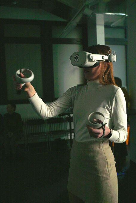 Artist Anne Pflug creating a virtual reality painting sculpture wearing Oculus at Non Fungible Female Art Festival in February 2023