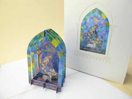 carte pop-up crèche de noël représentant la nativité dans un vitrail de chapelle d'église