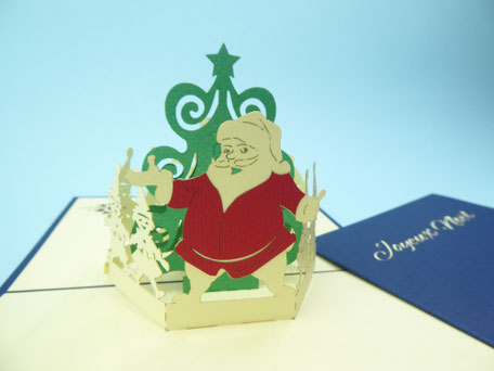 carte pop-up joyeux noël avec un père noël, un bonhomme de neige et des lutins autour d'un sapin