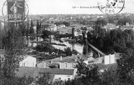 Au premier plan, le village de Fissac ; au fond, la passerelle arrive au petit port des Seguins (carte envoyée en 1908).
