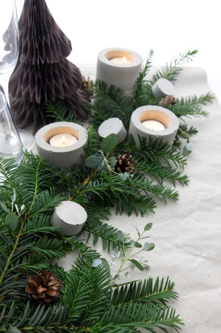 Festive Table Settings For Christmas With Evergreens And Concrete Accents By PASiNGA