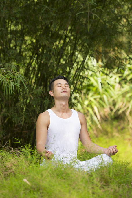 A man breathing deeply at a park