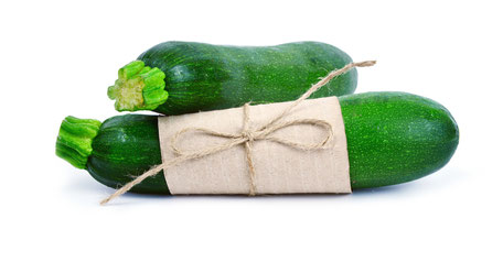 Zucchini squash (courgette) is one of the most vegetable for weight loss. Zucchini squash (courgette) on white background with brown paper hold with rope.