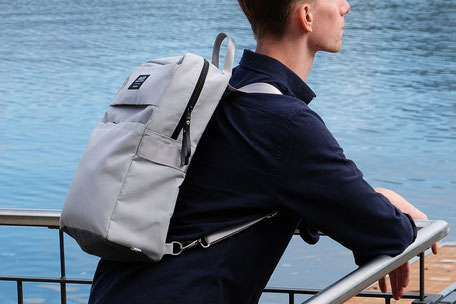 Backpack - Universal Design backpack project - Man with universal backpack on his shoulder watching the lake leaning against a parapet  - wheelchair backpack - inclusive design - backpack - swiss made