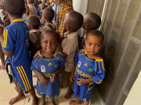 Eine Gruppe von Kleinkindern in blau gelber Kleidung
