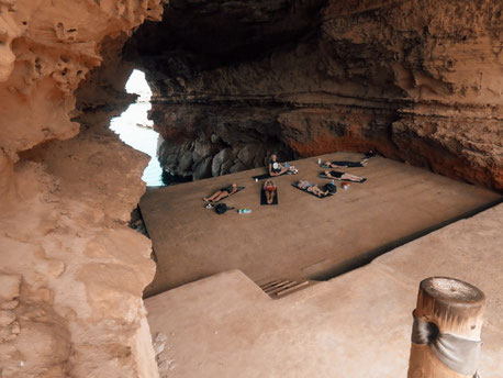 group practicing yoga in cave of Ibiza