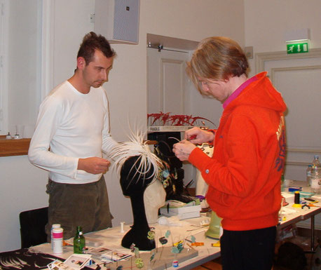 Markus Ehrhard and Philip Treacy working on the Andy Warhol Wig made of feathers in Paris.