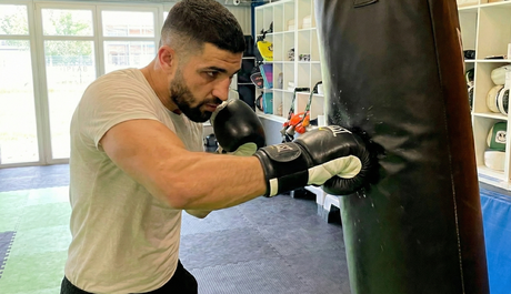 Trainer Daniel am Boxsack beim BoxTraining - Vorstellung Kurs Boxen Friesoythe mit Boxhandschuhen