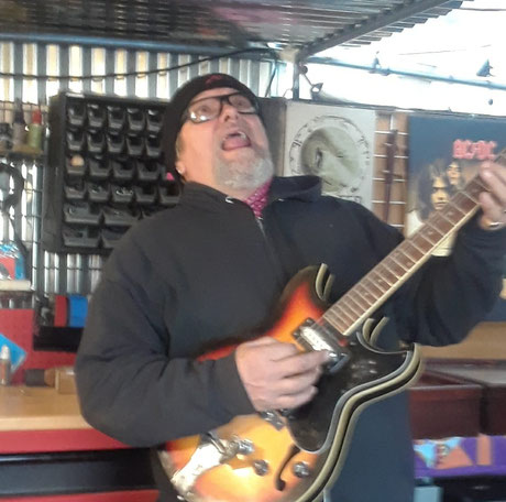 Sunnybaby of "Sunnybaby's Geetar City," jamming out! Photo from the store's Facebook page take in April 23, 2018.