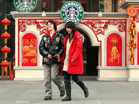 Beijing couple stands outside of Starbucks. By Thirdage.com via Pintrest. 