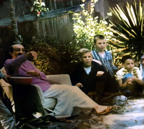 Baba in the compound with Larry on the far right. Cropped photo - see above for original image.