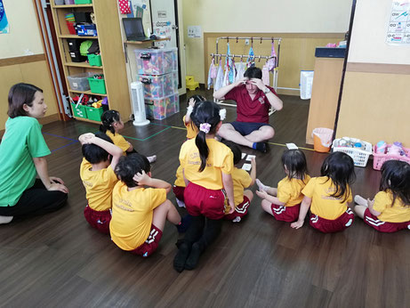 A picture of the kids playing a game with the school principal