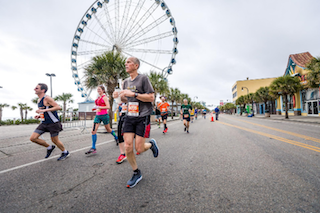 Reverse Running Group Participating in Marathon