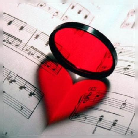 lente tonda che rispecchia un cuore rosso su spartito
