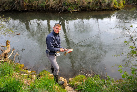 The Danica Dudes member Church catching a brown trout with a flyrod in the Lauterach
