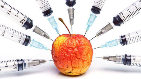 Harmful chemicals being injected into an apple