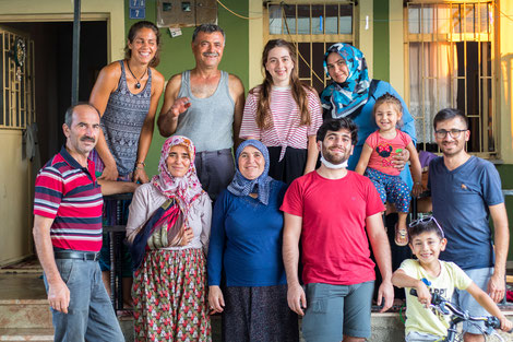 Isa's family in front of their family home 