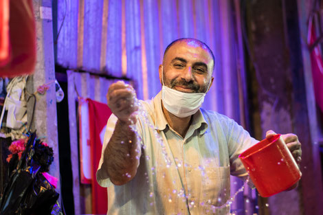 At the bazar in Izmir. A man watering his fish