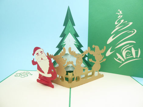 carte pop-up père noël près du sapin avec ses rennes style humoristique, carte de noël pour enfant