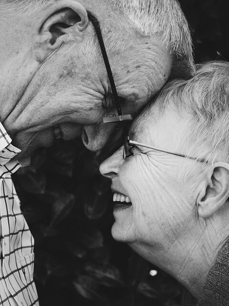 Old couple laughing.