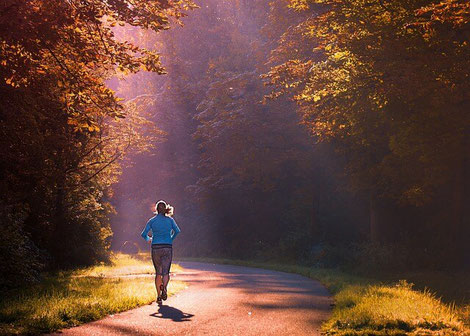 Woman jogging on road.