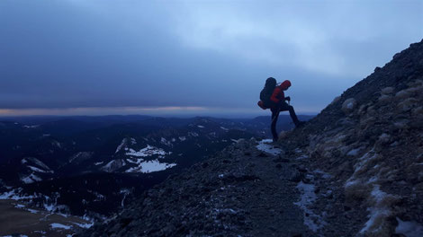 The stony ascent to the summit under a big cloud formation with an interesting sunset.