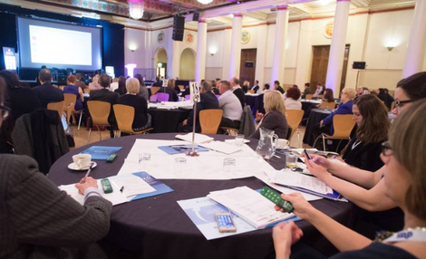 Delegates using voting handsets to reply to onscreen questions