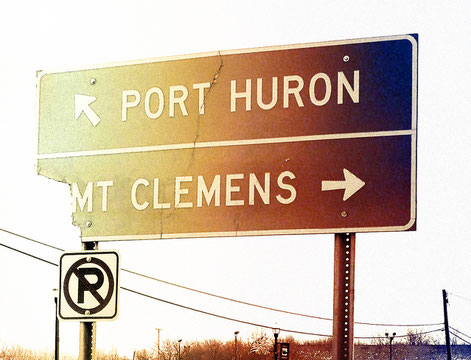 Street sign showing Port Huron, MI in St. Clair County and Mt. Clemens, MI in Macomb County