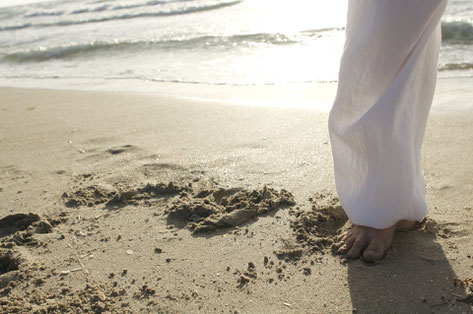 Sun shining in the beach/sea, while doing light exercises