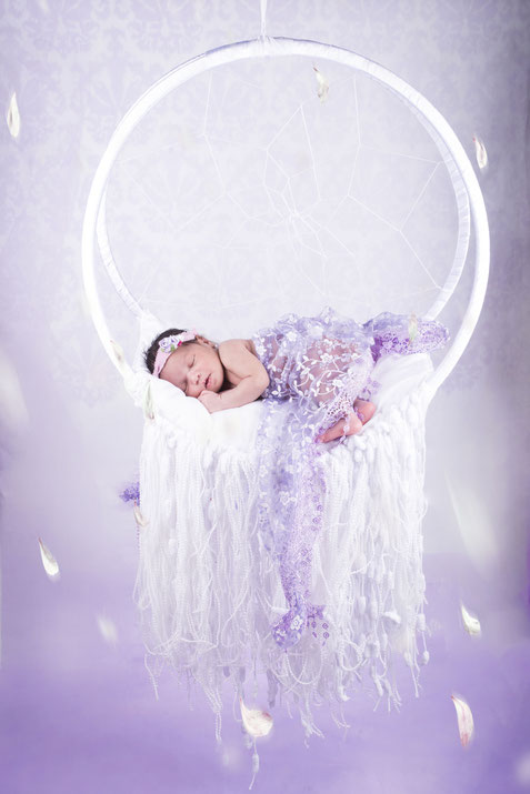 newborn lying in beautiful prop