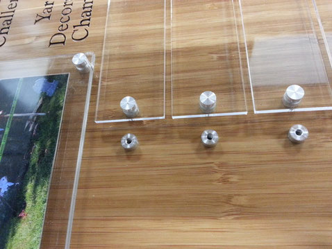Bamboo award/plaque with custom machined stand-offs for the acrylic name plates. Closer views of the standoffs can be found in the machining section of this site.