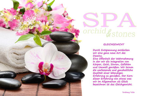 Orchiden & Massagesteine mit Text über das Gleichgewicht