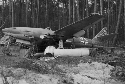 No.2) A  couple of days later. Someone cam to the ingenious idea to take the lift away. The aircraft tipped over and is now resting on its starboard wing. The engine cowlings are visible in the foreground.