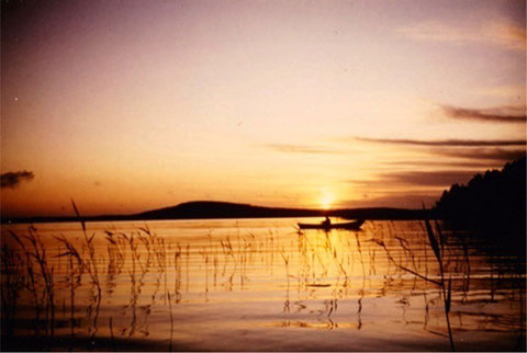 Genießen Sie entspanntes Angeln im eigenen Boot bei Sonnenaufgang in  den Schilfzonen der Bucht vor dem Haus. Im Hintergrund der 1,5 km vom Haus entfernte "Berg" mit Aussichtsturm der Insel Päijätsalo bei Sonnenaufgang.