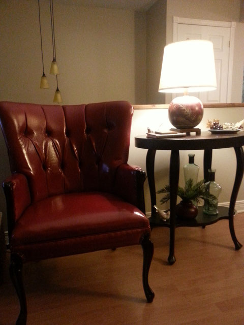 Antique chair reupholstered in dark red faux leather