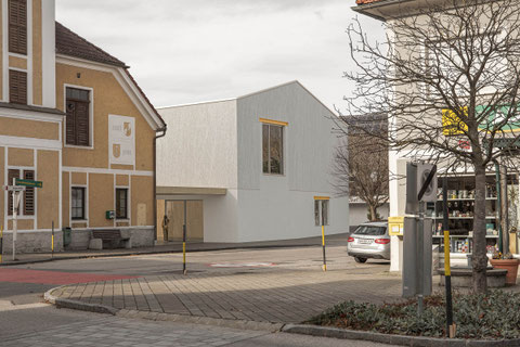 Architectural competition with Caramel architecture. Reuse of an old fire Station in St. Peter lower Austria. Exterior visualization showing the new building with rough white plastered facade.