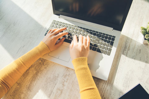 Photo of hands typing on a computer