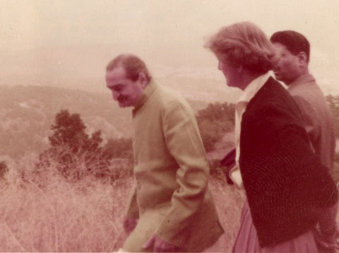 Avatar Meher Baba and Agnes Baron waling to Baba's Tree on August 2, 1956. Meher Baba's disciple Eruch Jessawala is in the background. (Archive photo.)