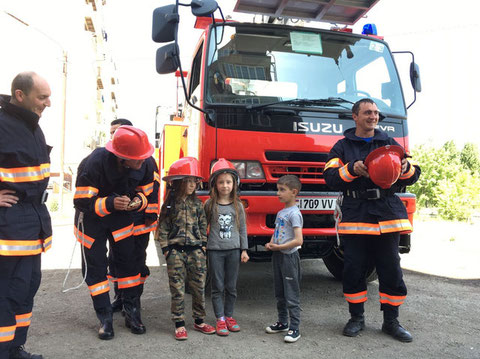 Armenian Firefighters and children in front of the ladder truck procured (Location: Vanadzor, May 2019)