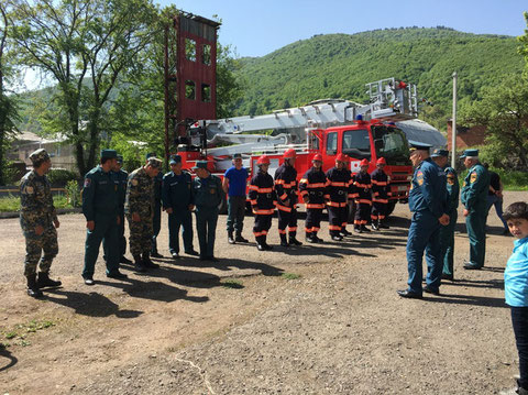 Armenian firefighters lined up in front of the ladder truck procured  (Location: Vanadzor, May 2019)
