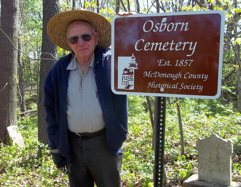 Dick Jackson accepts a sign for the Osborn Cemetery in Industry Township.