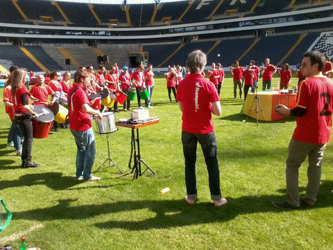 Picture of drummers during a teambuilding workshop in a soccer stadium