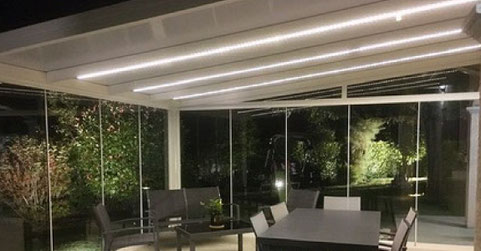serre de jardin d'hiver est une pergola fermée par des panneaux de verre Securit qui coulissent sur une armature aluminium très discrète