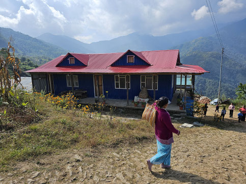 blaues Hostelgebäude mit rotem Dach - der Schule in Nepal 