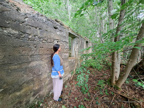 Ruins of old manor house and trees with a girl in a blue blouse in Zvarde Parish, Latvia