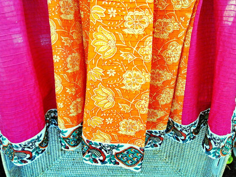 Pink & orange, floral block print, pinched pleat, Indian cotton throw; view of green & rust peacock jari border