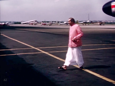 Meher Baba walking to the terminal at Washington, DC. Image captured by Anthony Zois from a film by Sufism Reoriented.